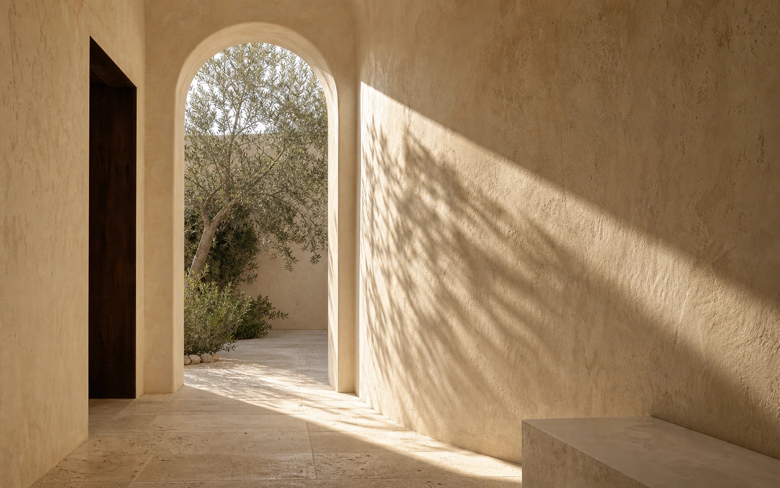Natural sunlight shaping a warm mineral-plaster passage